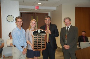 Chair Martin and Director Bryant present student trustees Aaron and Jen with a plaque, and thank them for a great year of service.