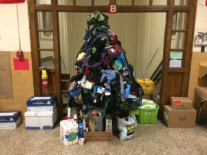 Holiday tree covered in winter accessories for charity.