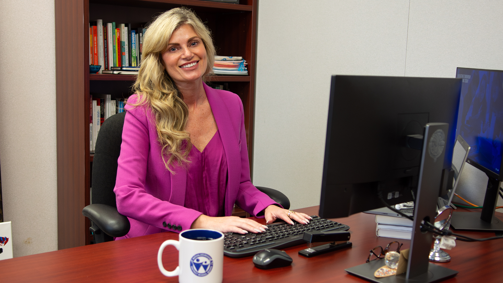 Evelyn sits at her desk