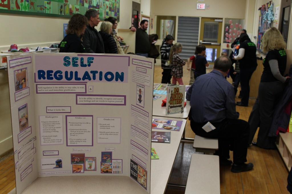 Parents and their children participate in a self regulation activity.