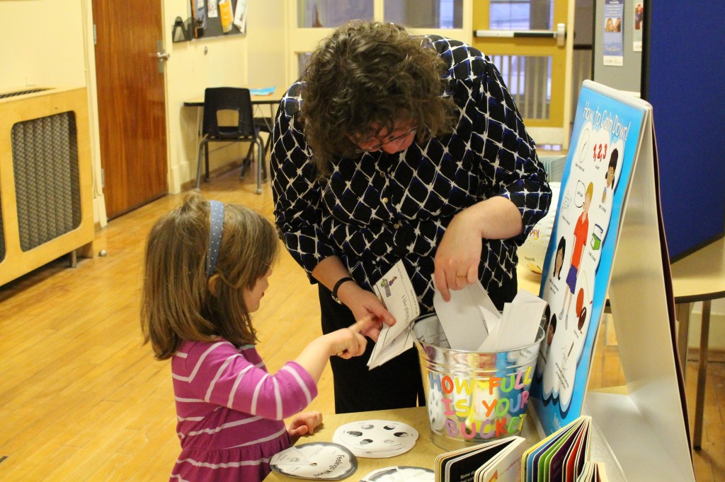 A representative from Carizon showing a Suddaby PS student so at-home activities.