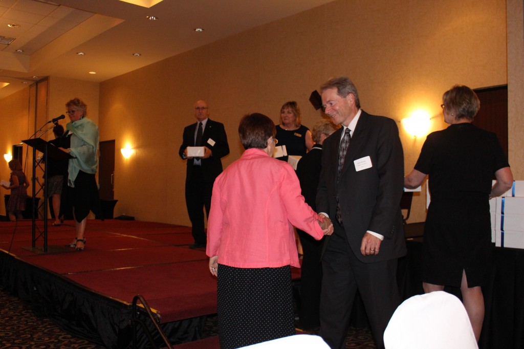 Retirees making their way to the stage to receive their gift.