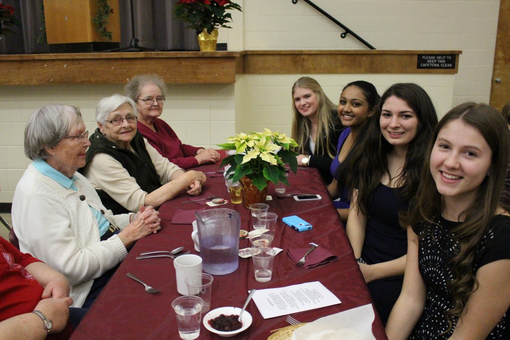 PHS students enjoying a meal with their table guests.
