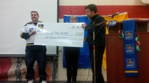 Steve Cabral and Cathy Tavener from RBC, present Panther Hockey Coach Steven Sanderson with a cheque for $2500.
