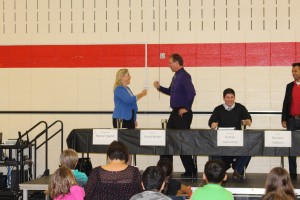 PC candidate Marian Gagne and Green Party candidate David Weber battle it our with rock-paper-scissors to determine who speaks first.