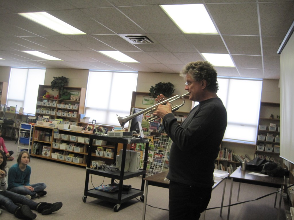 Daniel Warren, principal trumpet player from the symphony, visits school