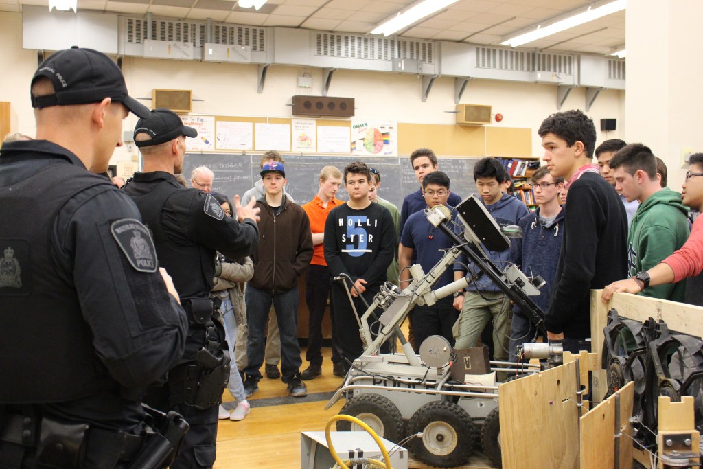 Cameron Heights CI students get a closer look at their new robot.