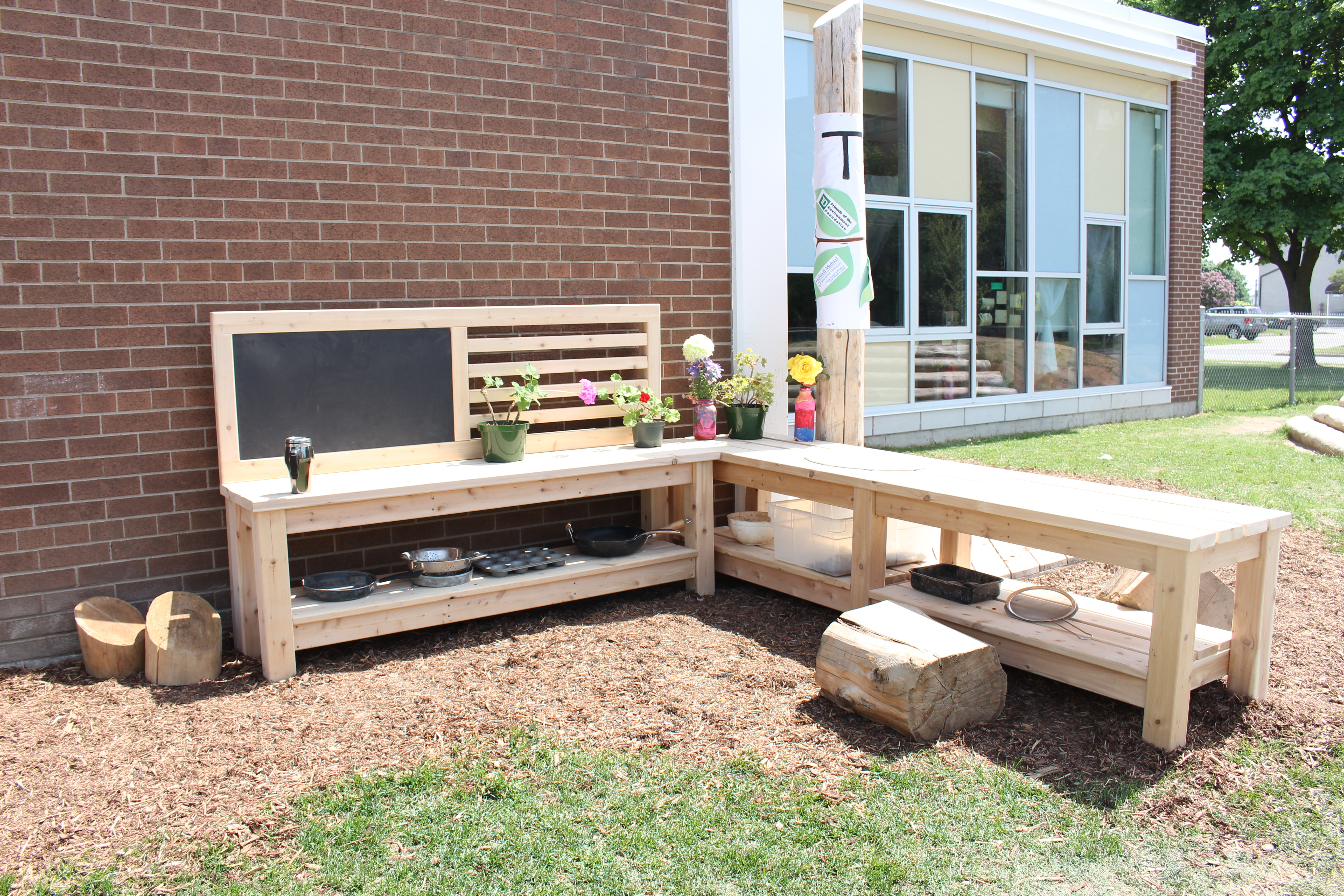 Rockway's new natural learning space is equipped with an outdoor play kitchen!