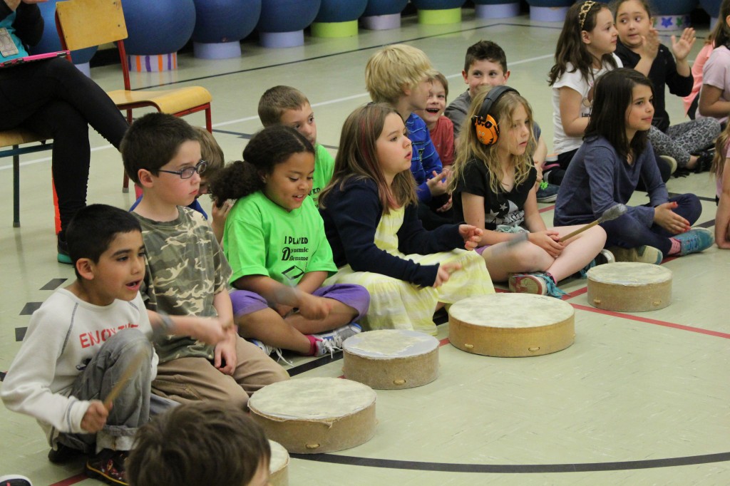 Students playing along on the drums.