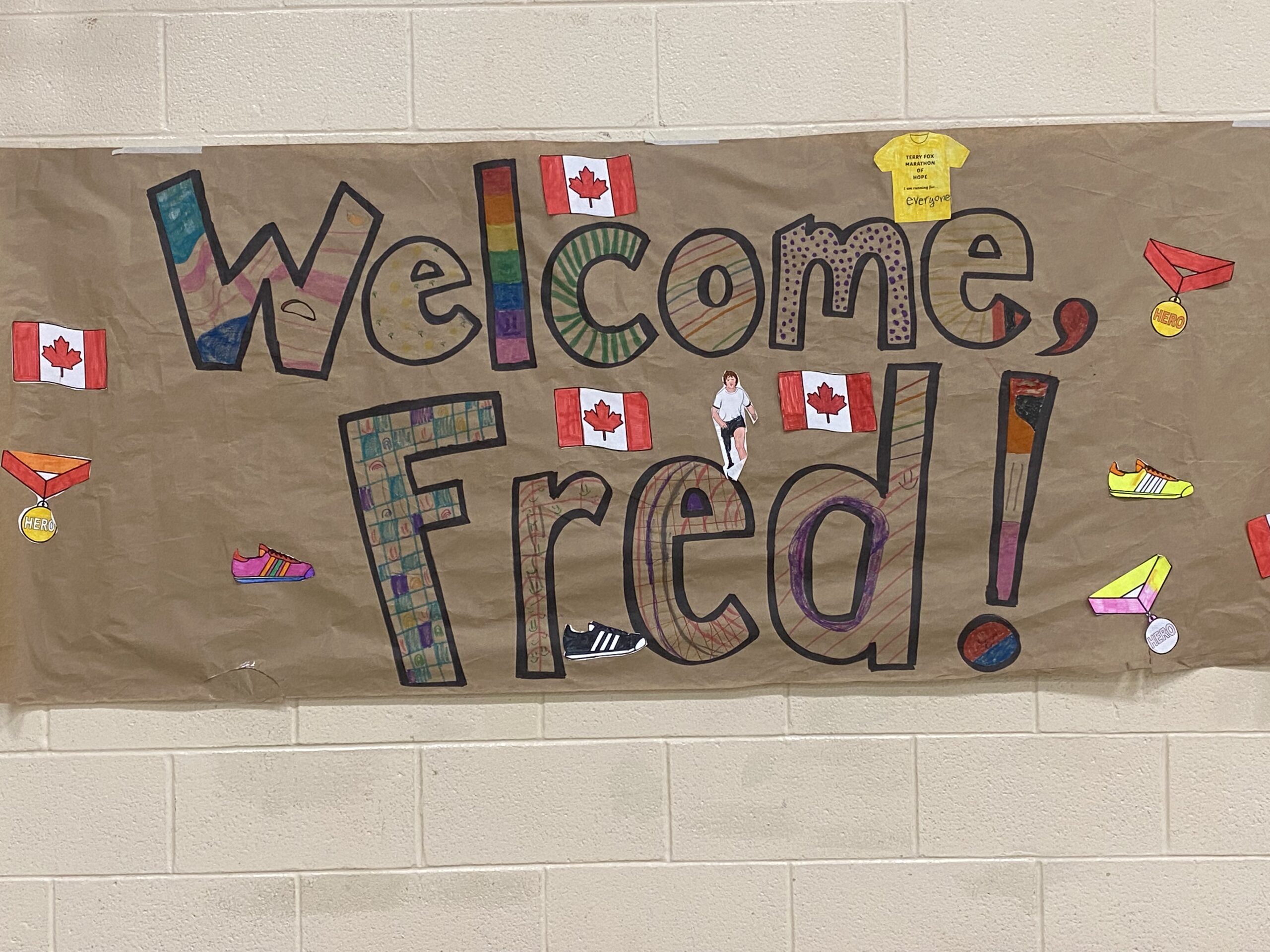 A large, handmade banner reads "Welcome Fred"