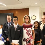 Kyle receives his award from Linda Fabi, with his family and staff from Bluevale CI