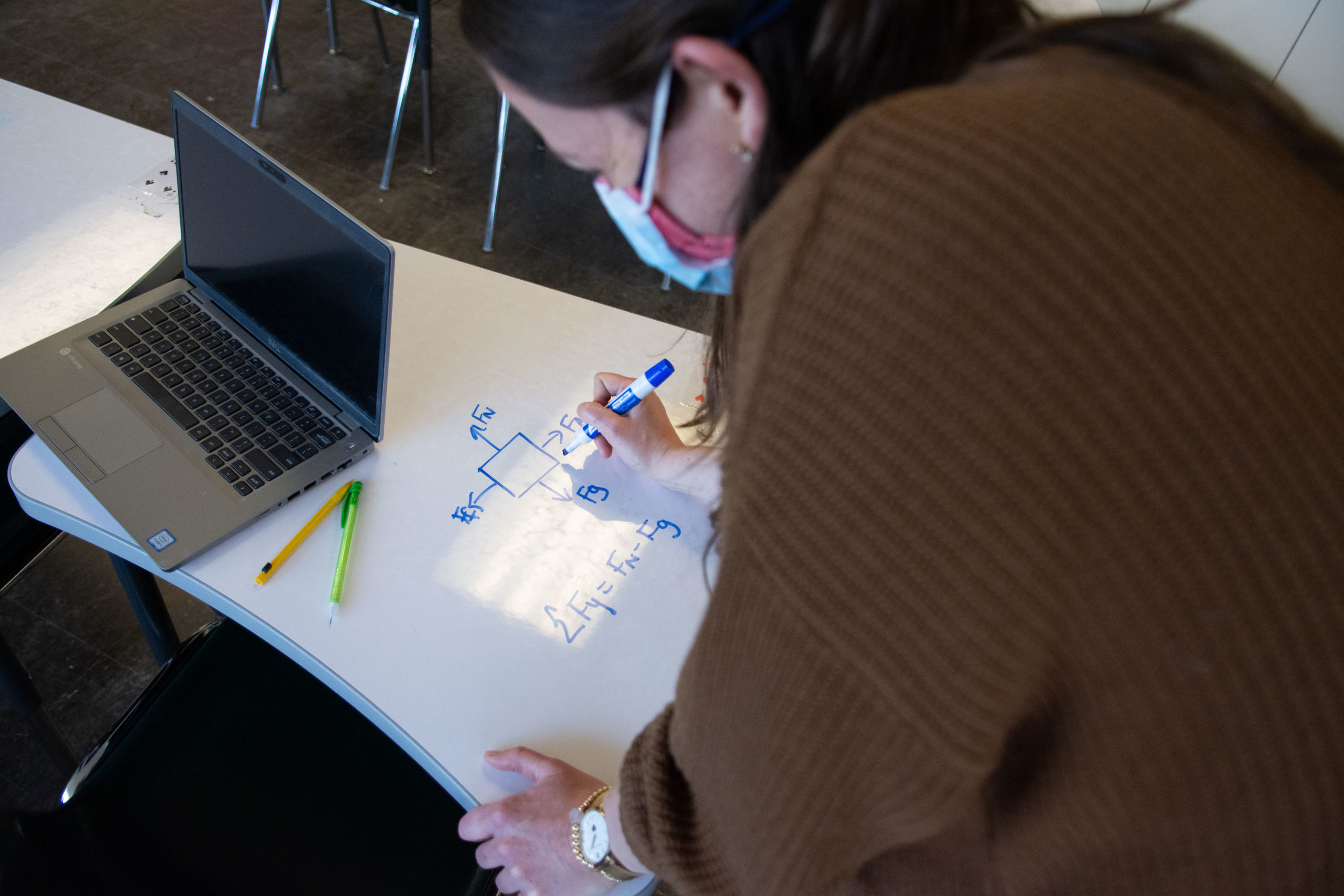 Ashley McCarl Palmer uses a whiteboard desk in her classroom to write out an equation