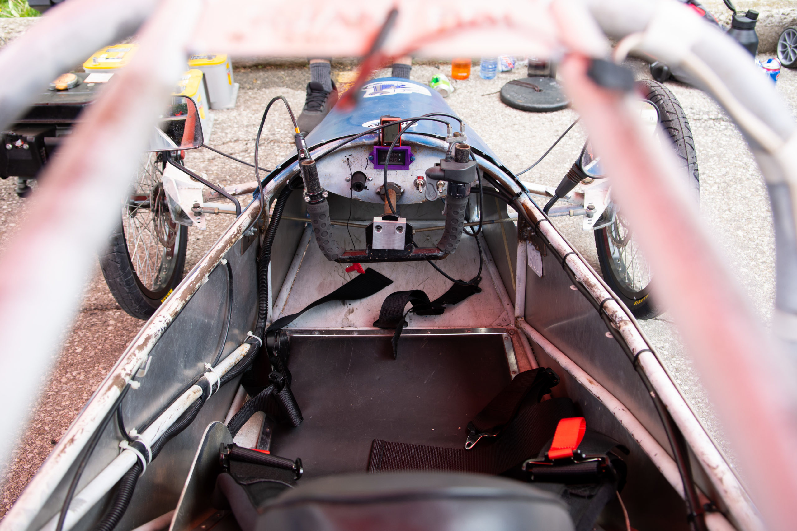A look inside the cockpit of a student built electric car. The steering yoke, various switches and instruments are all visible. 
