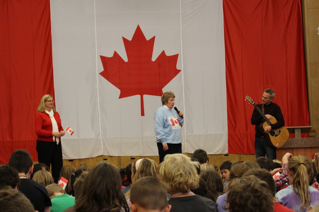 Left to right: Sharon Scott, one of Smithson's choir leader, Diane Bonafonte, a member of the 'Flag Wavers of Waterloo Region', and Steve Bergen, composer and Smithson teacher.